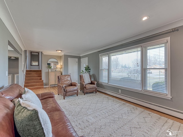 living room with wood finished floors, a wealth of natural light, stairs, and baseboard heating
