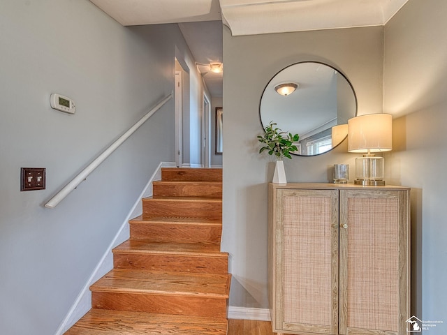 stairs featuring baseboards and wood finished floors