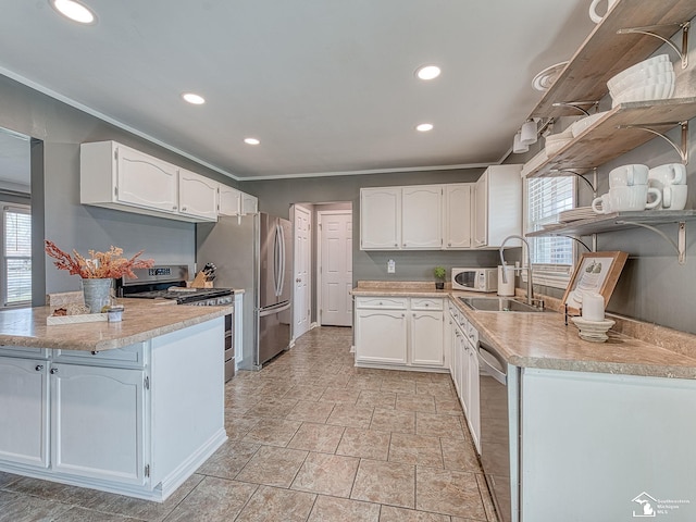 kitchen featuring white cabinets, a peninsula, appliances with stainless steel finishes, and open shelves