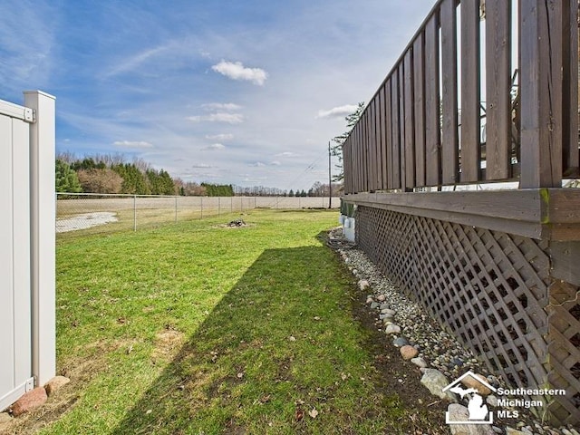 view of yard with fence and a rural view