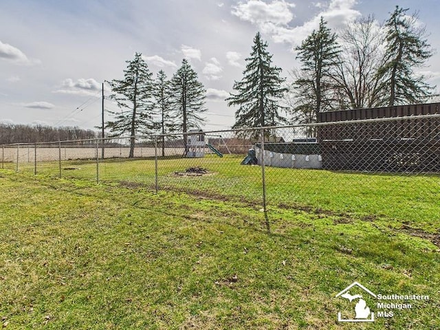 view of yard with a playground and fence