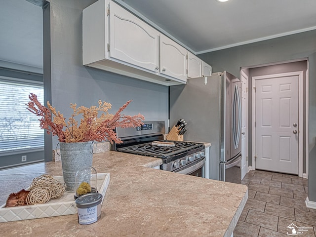 kitchen featuring baseboards, white cabinets, stainless steel appliances, and light countertops