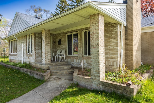 12600 Hayes St, Detroit, MI 48205 - property entrance featuring covered porch, a chimney, brick siding, and a shingled roof