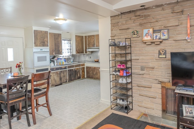 12600 Hayes St, Detroit, MI 48205 - kitchen featuring under cabinet range hood, a sink, and white double oven