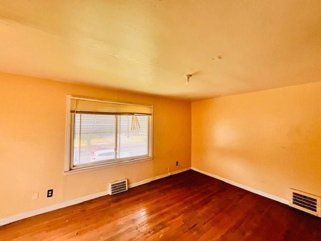 15732 Meyers Rd, Detroit, MI 48227 - unfurnished room with baseboards, visible vents, and wood finished floors