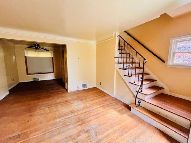 15732 Meyers Rd, Detroit, MI 48227 - interior space featuring stairs, visible vents, wood finished floors, and baseboards