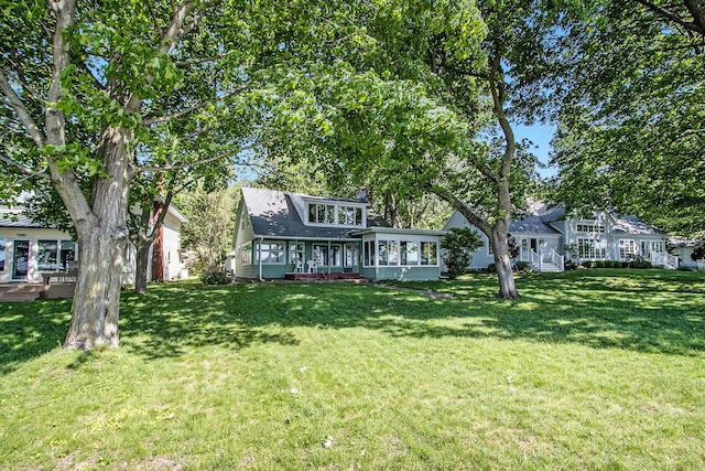 view of front of home with a front lawn and roof with shingles