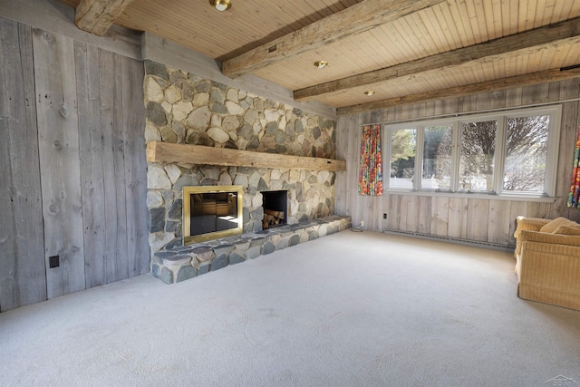 unfurnished living room featuring wooden ceiling, carpet floors, beam ceiling, a fireplace, and a baseboard heating unit