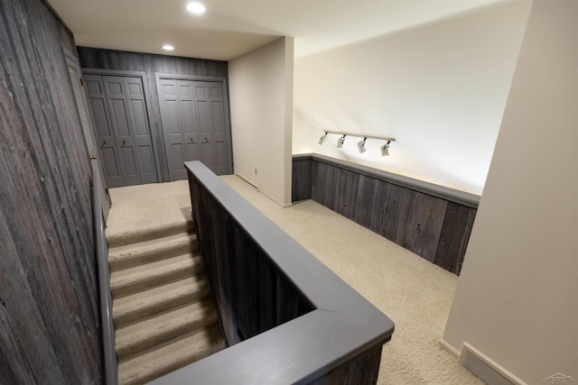 stairway with carpet flooring and recessed lighting