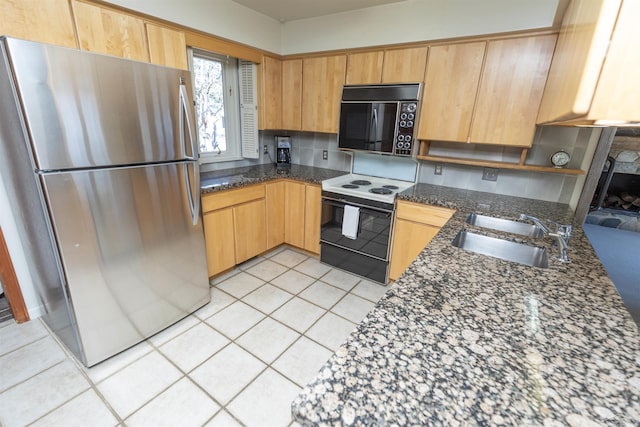 kitchen featuring a sink, light tile patterned flooring, freestanding refrigerator, black microwave, and range with electric cooktop