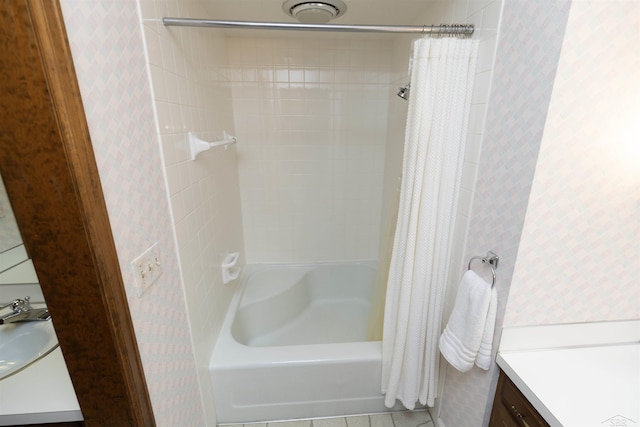 bathroom featuring shower / bath combo with shower curtain, vanity, tile patterned flooring, and wallpapered walls