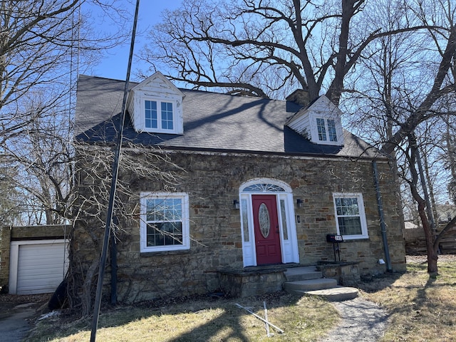 345 S Cochran Ave, Charlotte, MI 48813 - cape cod-style house featuring a shingled roof and stone siding
