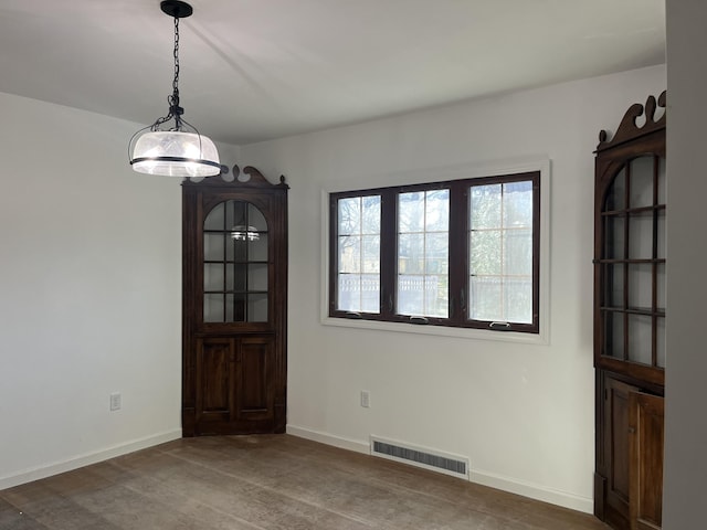 345 S Cochran Ave, Charlotte, MI 48813 - unfurnished dining area with baseboards and visible vents
