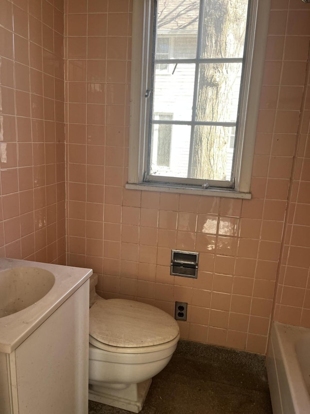 345 S Cochran Ave, Charlotte, MI 48813 - full bathroom with vanity, a bathing tub, toilet, and tile walls
