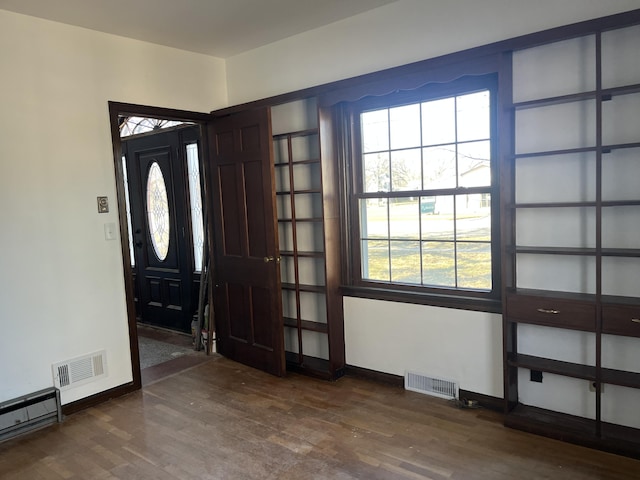 345 S Cochran Ave, Charlotte, MI 48813 - foyer entrance featuring visible vents, baseboards, and dark wood-style flooring