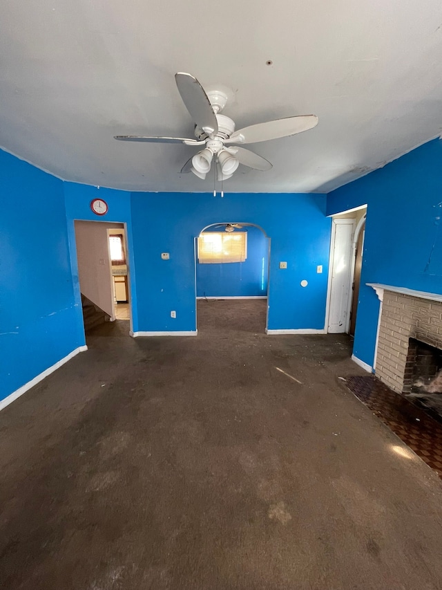 14811 Robson St, Detroit, MI 48227 - unfurnished living room featuring baseboards, ceiling fan, and a brick fireplace