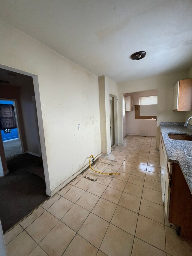 14811 Robson St, Detroit, MI 48227 - kitchen featuring baseboards, a sink, and light tile patterned floors