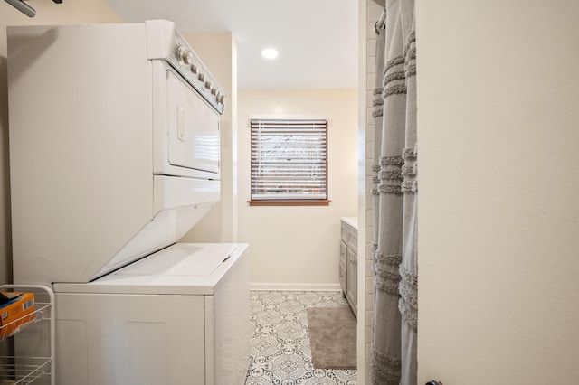 washroom with stacked washer and clothes dryer, recessed lighting, baseboards, light tile patterned flooring, and laundry area