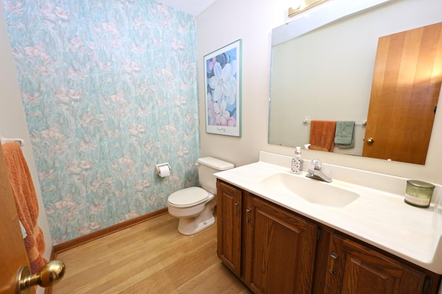 1381 Silverbrook Ln, Saint Joseph, MI 49085 - full bathroom with wood finished floors, vanity, baseboards, toilet, and wallpapered walls