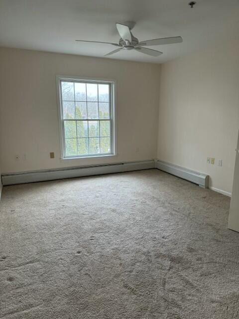 unfurnished room with baseboard heating, carpet, and ceiling fan