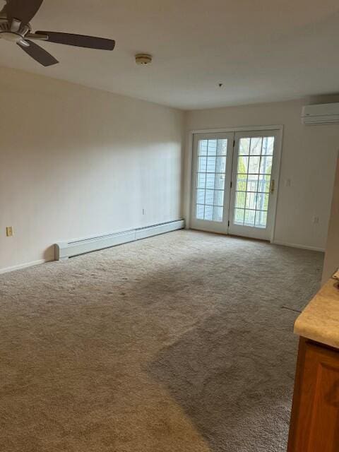 unfurnished living room with carpet flooring, a ceiling fan, a baseboard heating unit, baseboards, and an AC wall unit