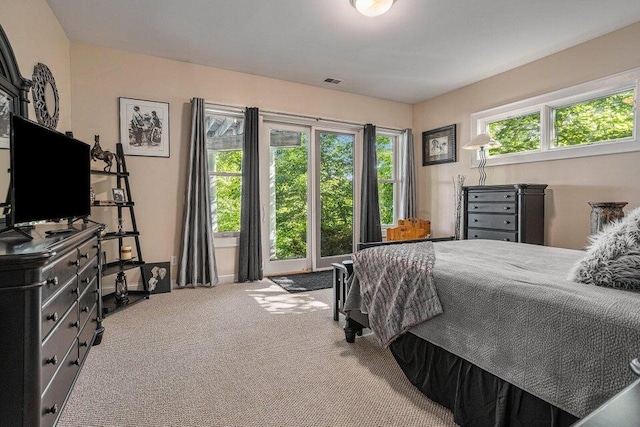 carpeted bedroom featuring visible vents