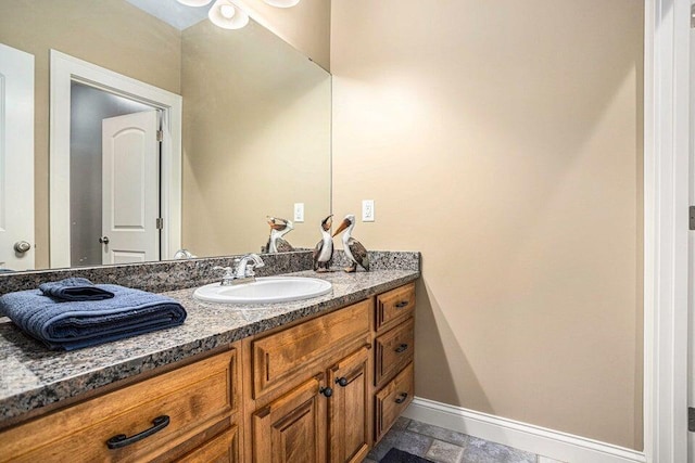 bathroom featuring baseboards and vanity