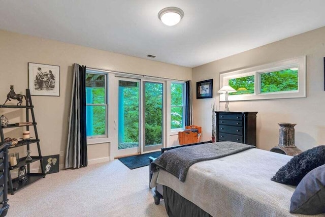 carpeted bedroom with access to exterior and visible vents