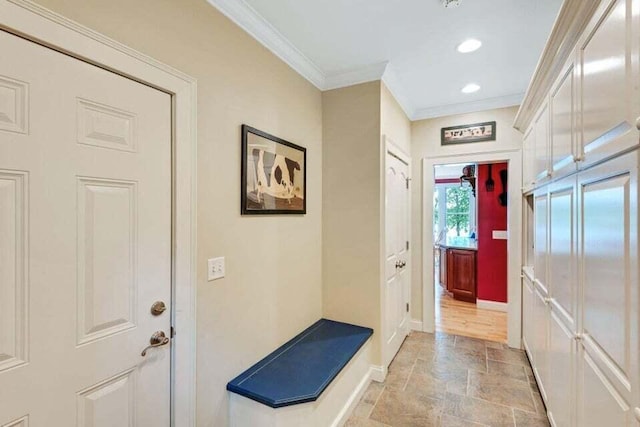 doorway to outside featuring recessed lighting, ornamental molding, baseboards, and stone finish floor