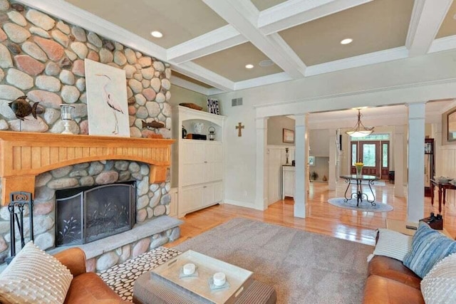 living room featuring coffered ceiling, decorative columns, wood finished floors, visible vents, and beamed ceiling