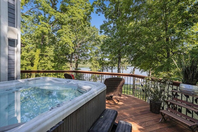 wooden deck with grilling area and a hot tub