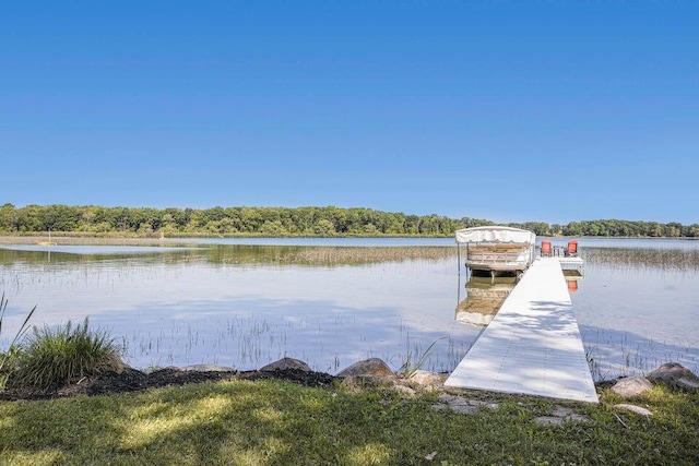dock area with a water view and a forest view