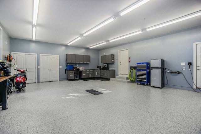garage with freestanding refrigerator