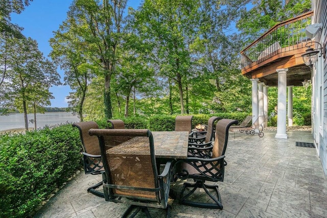 view of patio featuring a water view and outdoor dining space
