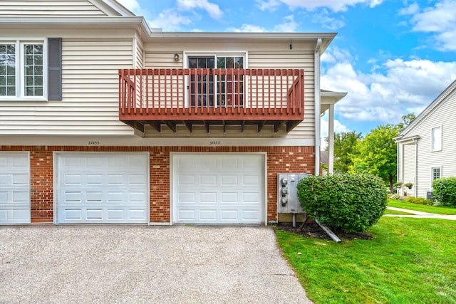37457 Stonegate Cir, Clinton Township, MI 48036 - view of front of home featuring a balcony, driveway, a garage, brick siding, and a front yard