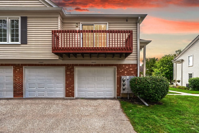 37457 Stonegate Cir, Clinton Township, MI 48036 - view of front of home with a balcony, a garage, brick siding, asphalt driveway, and a front lawn