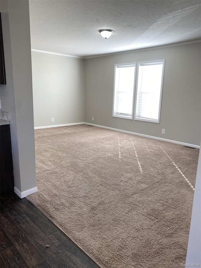 33123 Aspen Ct, New Haven, MI 48048 - empty room with dark carpet, dark wood-type flooring, a textured ceiling, and crown molding