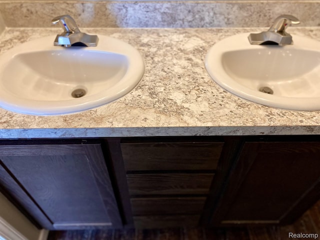 33123 Aspen Ct, New Haven, MI 48048 - bathroom featuring double vanity and tasteful backsplash