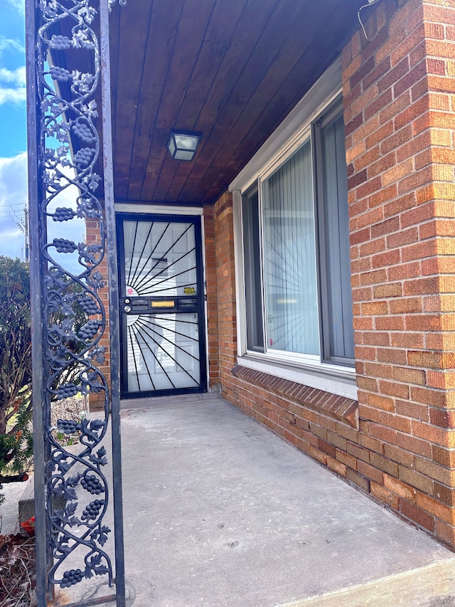 property entrance with brick siding