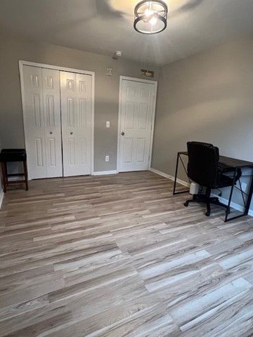 office with baseboards and wood finished floors