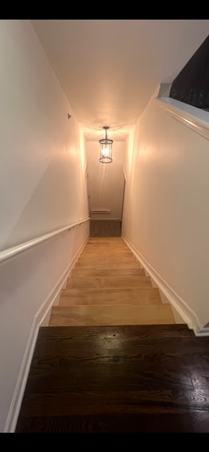 stairway with wood finished floors