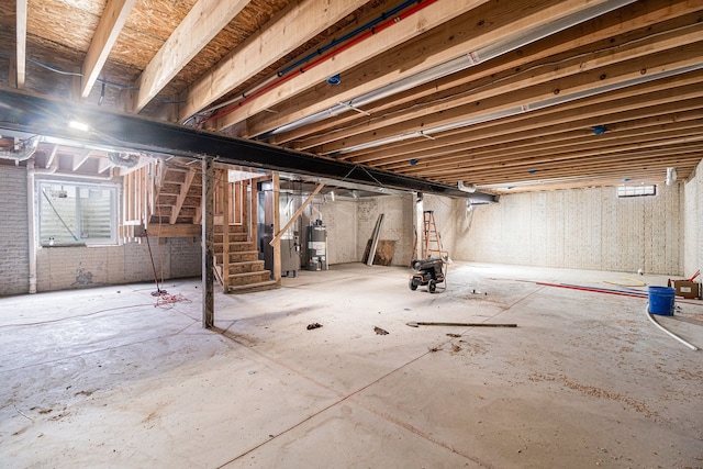 23708 Lexington Ave, Eastpointe, MI 48021 - below grade area featuring water heater, brick wall, and stairway