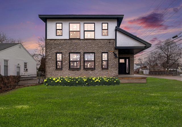 23708 Lexington Ave, Eastpointe, MI 48021 - view of front of home with brick siding, stucco siding, fence, and a front lawn
