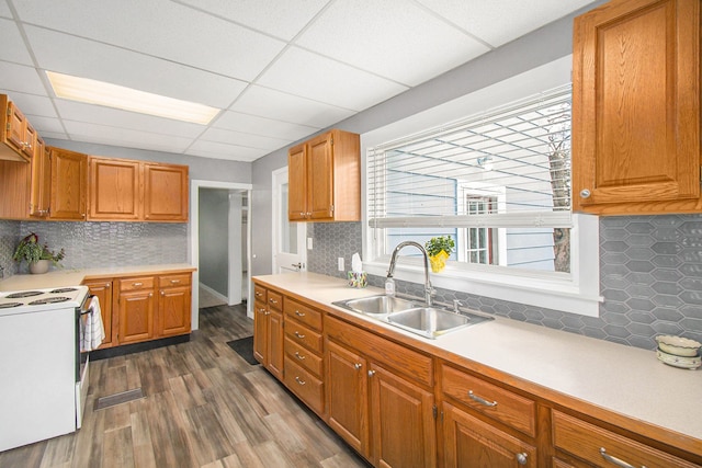 54 Division St, Oxford, MI 48371 - kitchen with light countertops, backsplash, a sink, dark wood finished floors, and white electric range
