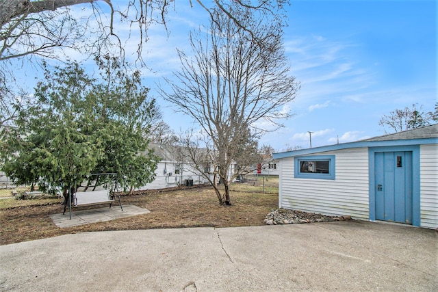 54 Division St, Oxford, MI 48371 - view of patio featuring an outbuilding and fence
