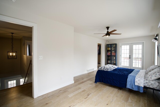 bedroom with french doors, baseboards, light wood finished floors, and visible vents