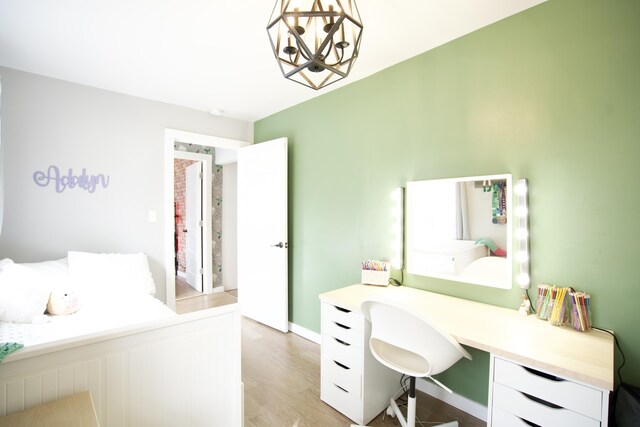 bedroom featuring a notable chandelier and light wood-style floors
