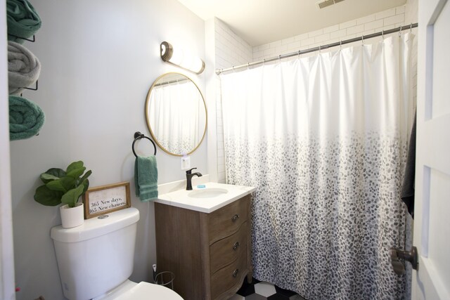 bathroom with toilet, vanity, and a shower with curtain