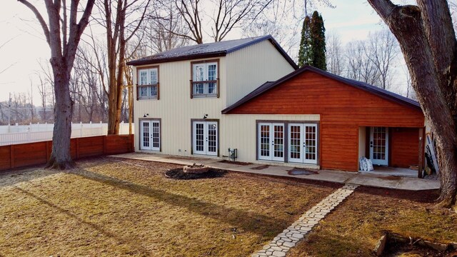 back of property featuring french doors, fence, and a patio