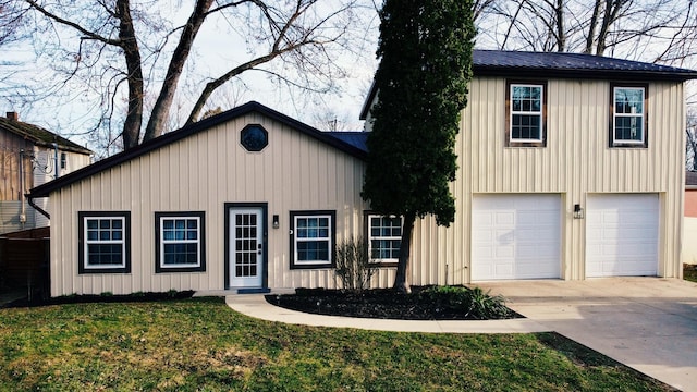 view of front of home featuring board and batten siding, concrete driveway, and an attached garage